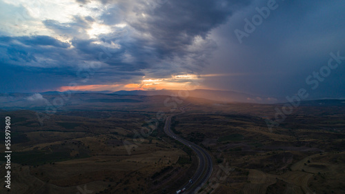 Aerial view of highway and sunset.4K UHD Aerial photo.
