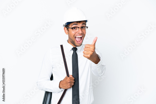 Architect brazilian man with helmet and holding blueprints with thumbs up because something good has happened