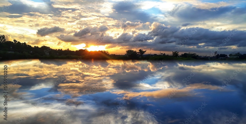 The evening offers some prime opportunities for wonderful photographs of beautiful landscapes. As soon as the sun goes down .In this photo the evening  sky is reflecting on a clean pond .