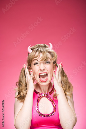 Portrait of Woman Wearing Devil Horns and Screaming
