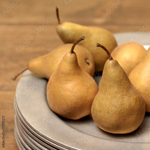 Bosc Pears on Stack of Plates photo