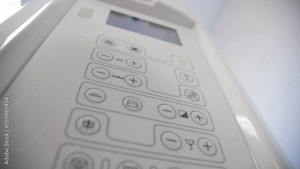 Control panel of electric equipment with keys on white wall close low angle shot. Device with buttons in light room Control panel of electric equipment with keys on white wall close low angle shot. Device with buttons in light room