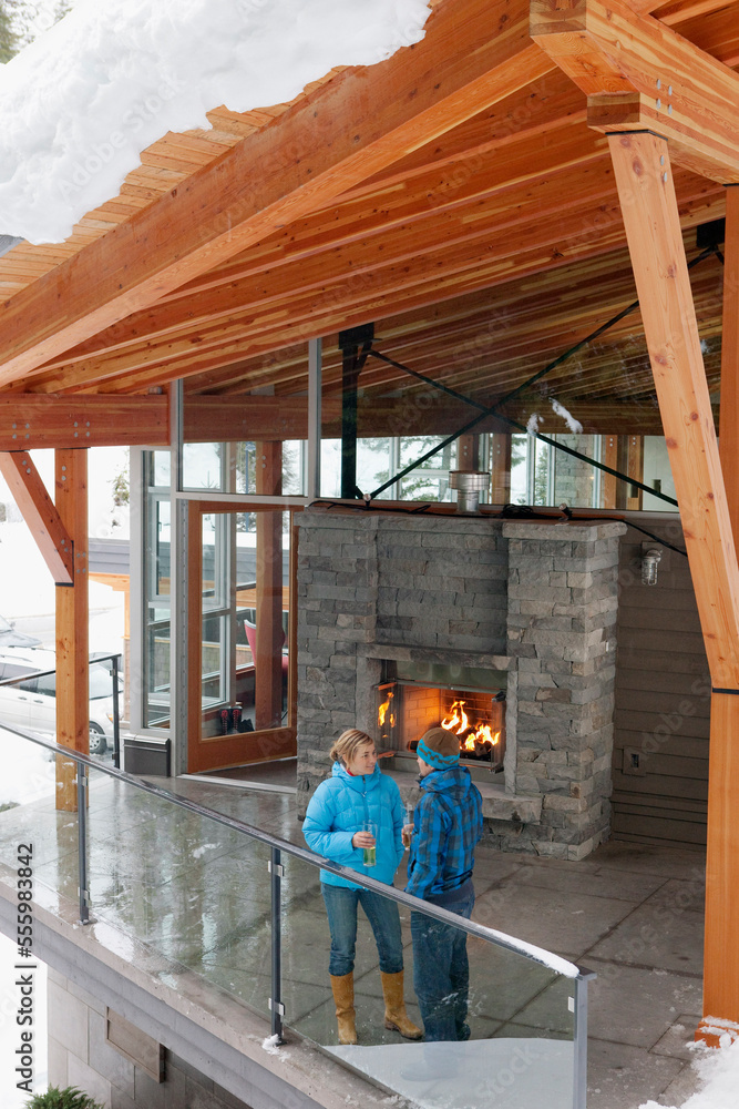 Man and Woman Standing on Chalet Balcony, Whistler, British Columbia, Canada Man and Woman Standing on Chalet Balcony, Whistler, British Columbia, Canada