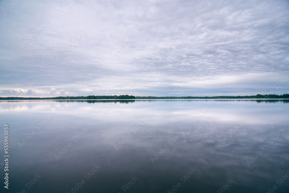 Cloudy mornimg over lake in summer