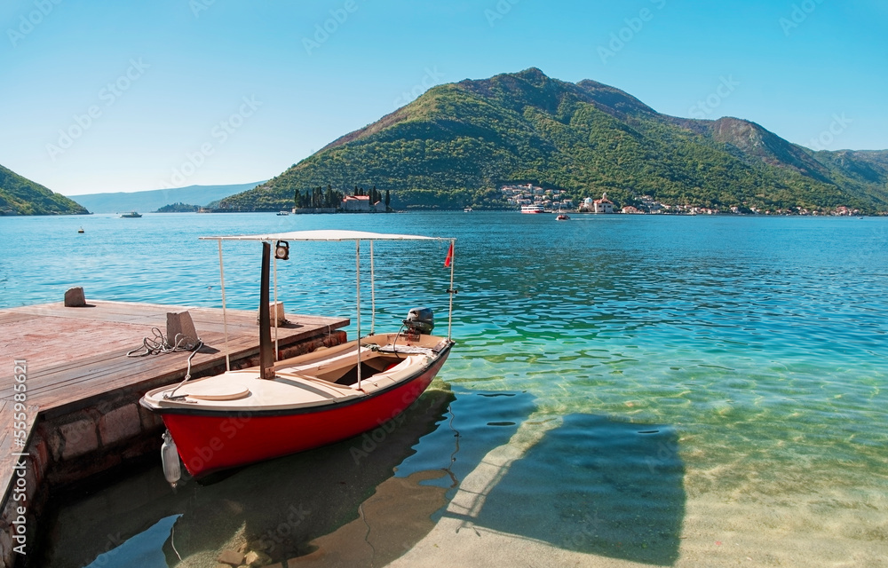 Red boat in the Bay of Kotor in the city of Perast