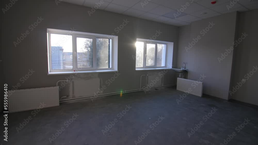 Radiators prepared for installation in empty room of renovated building. Heating equipment for home at construction site Radiators prepared for installation in empty room of renovated building. Heating equipment for home at construction site