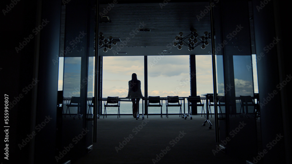 Woman silhouette enjoying break in conference room. Calm beautiful sea view. Woman silhouette enjoying break in conference room. Calm beautiful sea view.