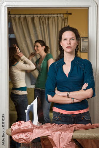 Teenaged Girl Doing Housework While Friends Party