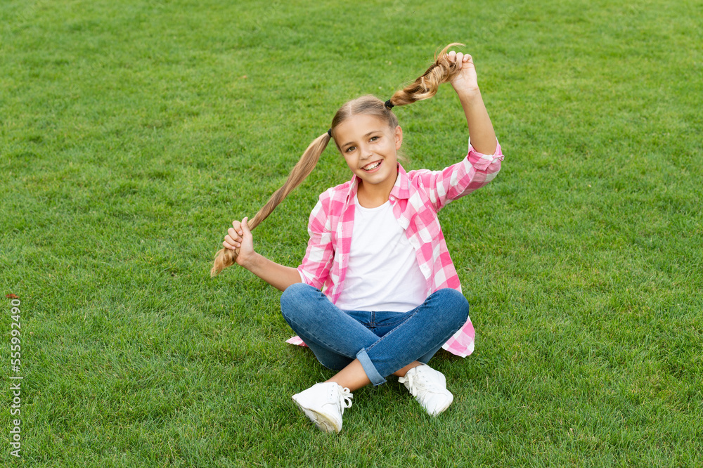 positive teen child sit on green grass outdoor positive teen child sit on green grass outdoor