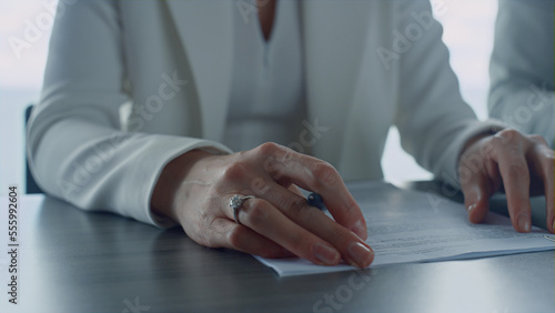 Business partners studying documents in office closeup. Hands holding papers