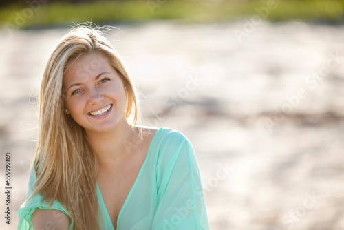 Close-up Portrait of Young Woman on Beach, Looking at Camera and Smiling, Palm Beach Gardens, Palm Beach County, Florida, USA photo