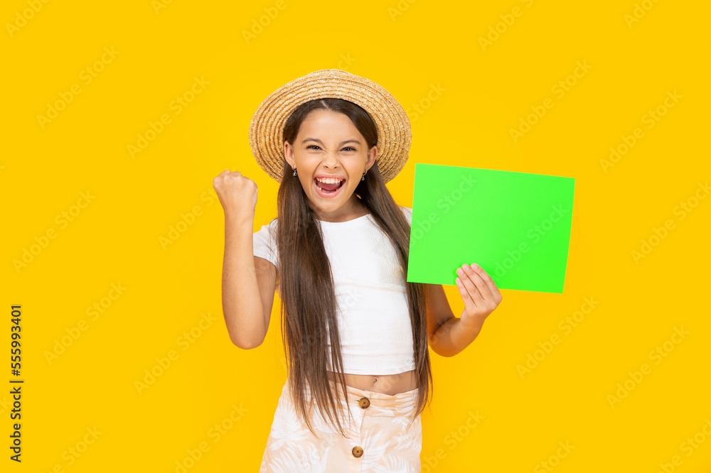 successful teen girl with copy space on green paper on yellow background successful teen girl with copy space on green paper on yellow background