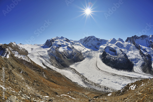 View from Gonergrat with Sun over Gorner Glacier, Monte Rosa Glacier and Monte Rosa Mountain Range, Zermatt, Alps, Valais, Switzerland photo