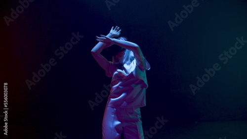 Futuristic woman dancing neon cyberspace in vr glasses. Happy gamer enjoying