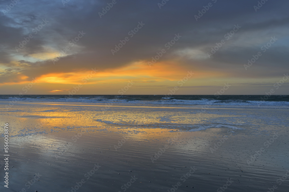 Sky at sunrise reflected on North Sea, beach and ocean at Helgoland, Schleswig-Holstein, Germany Sky at sunrise reflected on North Sea, beach and ocean at Helgoland, Schleswig-Holstein, Germany
