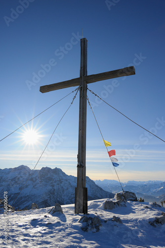 Cross and Buddhist Prayer Flags at Summit, Steinplatte, Waidring, Tyrol, Austria photo