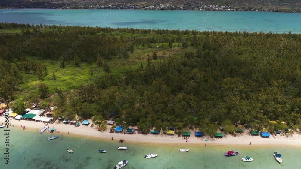 Aerial view of people on the beach with boats along the shore on Island Benetier, Mauritius. Aerial view of people on the beach with boats along the shore on Island Benetier, Mauritius.