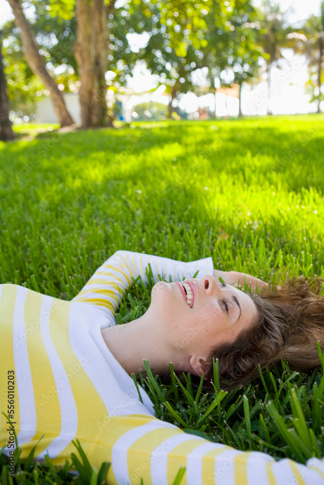 Woman Lying on Grass, Miami Beach, Florida, USA Woman Lying on Grass, Miami Beach, Florida, USA