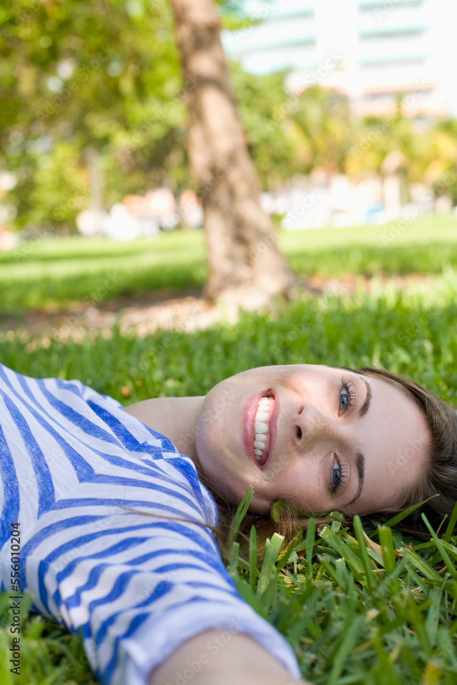 Woman Lying on Grass, Miami Beach, Florida, USA Woman Lying on Grass, Miami Beach, Florida, USA
