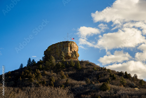 2022-12-22 A LARGE ROCK FORMATION ON A HILL WITH A METAL STAR FRAME AND FLAG IN CASTLE ROCK COLORADO