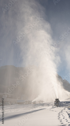 Snowmaking machine snow cannon or gun in action on a cold sunny winter day in ski resort Kranjska Gora, Slovenia