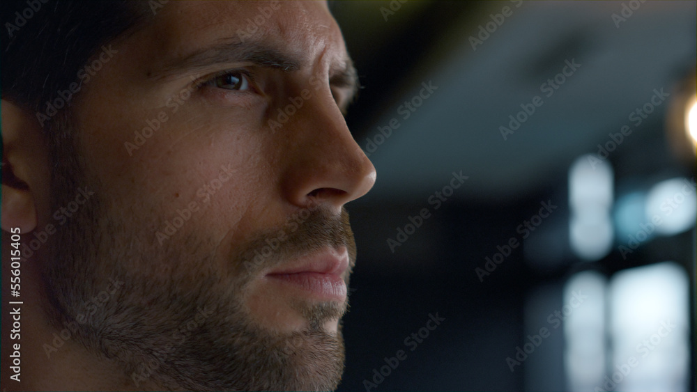 Closeup thoughtful man looking aside making decision in dark restaurant interior Closeup thoughtful man looking aside making decision in dark restaurant interior