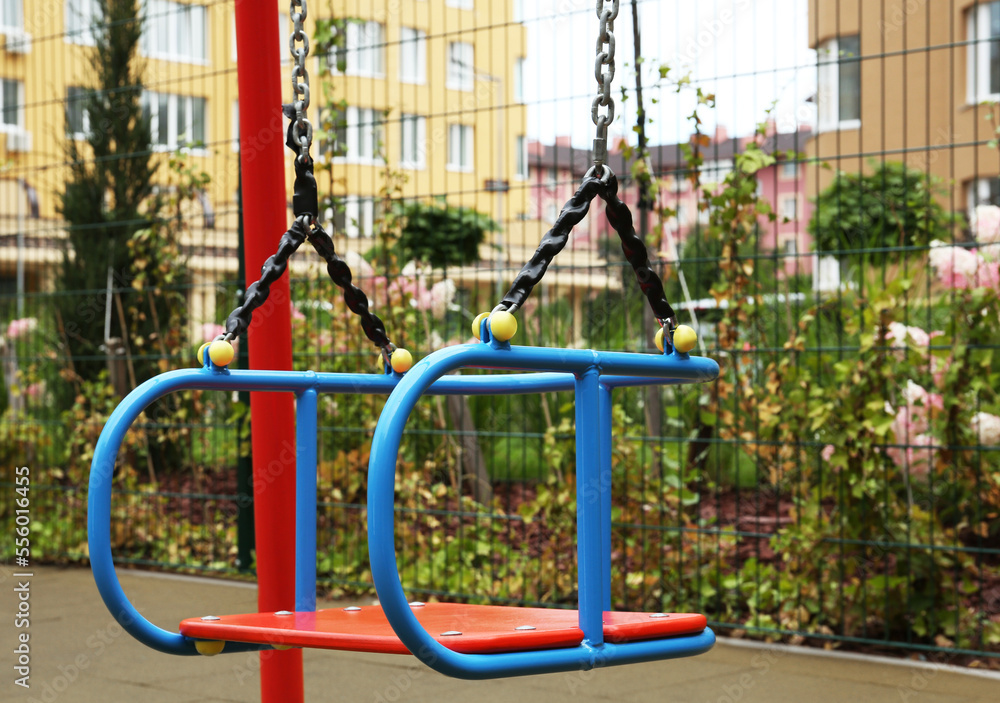 Swing on outdoor playground in residential area