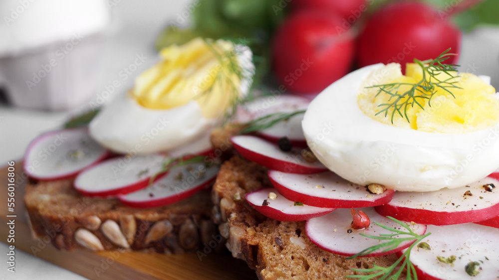 Tasty sandwiches with boiled egg and radish on table, closeup Tasty sandwiches with boiled egg and radish on table, closeup