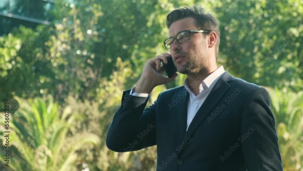 Outdoor portrait of a businessman speaking at the phone. businessman speak phone. Happy confident male professional manager web designer consulting client about online project making business call. Outdoor portrait of a businessman speaking at the phone. businessman speak phone. Happy confident male professional manager web designer consulting client about online project making business call.