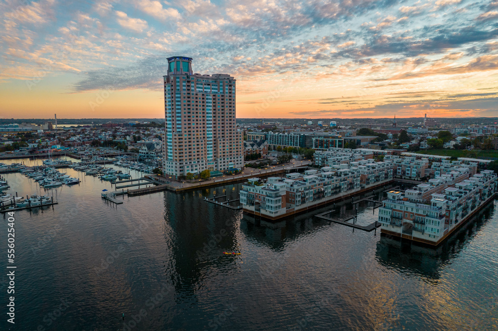 Aerial Drone View of Baltimore City Apartment Complex along the Water at Sunset with Boats Docked Nearby