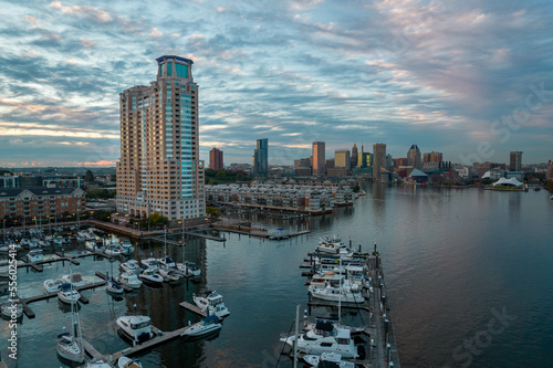 Aerial Drone View of Baltimore City Apartment Complex along the Water at Sunset with Boats Docked Nearby
