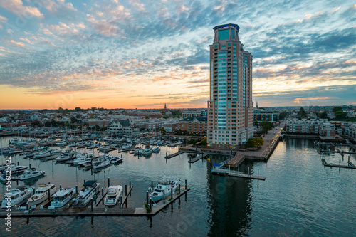 Aerial Drone View of Baltimore City Apartment Complex along the Water at Sunset with Boats Docked Nearby photo