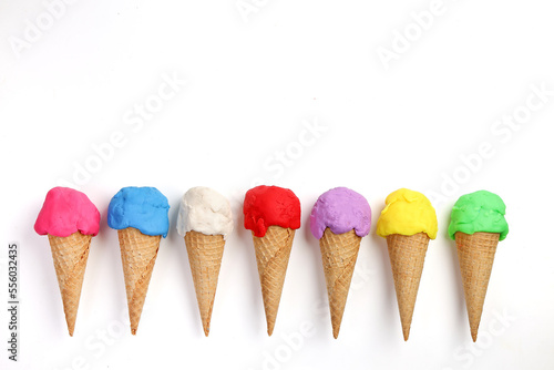 Fake modelling clay multi colourful ice cream on waffle biscuit cone flat lay top view on white background
