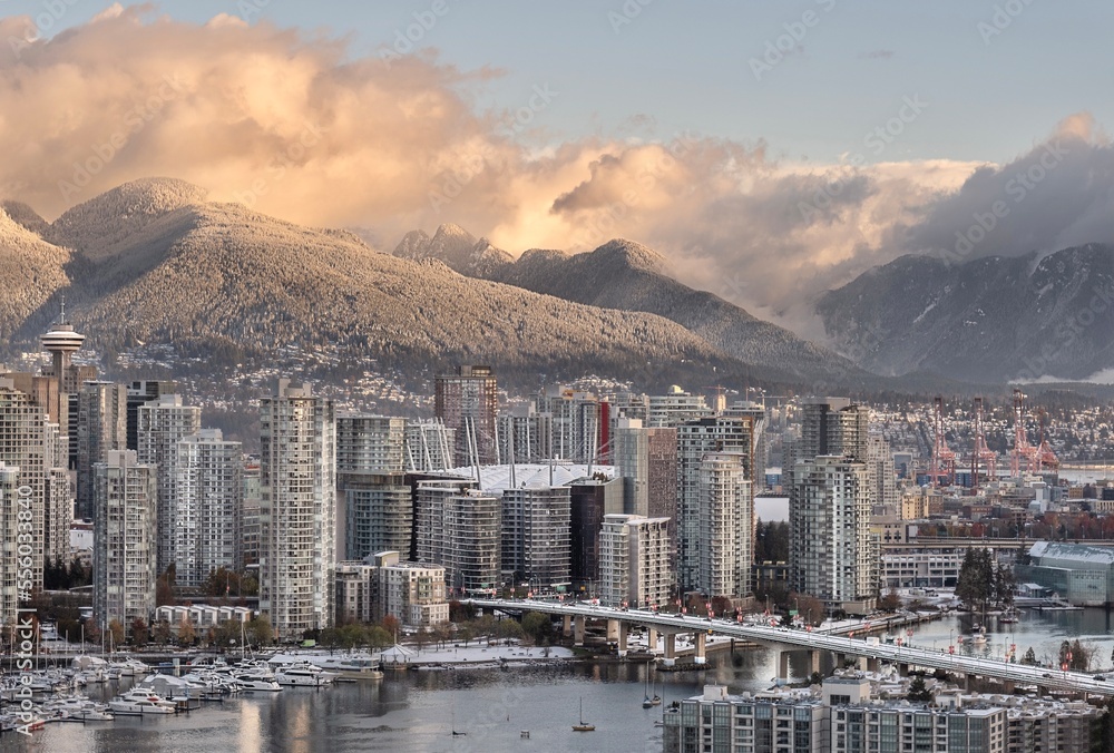 Fototapeta premium View of Vancouver and Cambie Bridge with mountains covered with snow in the morning light. Yaletown. British Columbia. Canada
