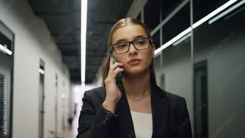 Closeup businesswoman talking phone in office. Sales manager calling client Closeup businesswoman talking phone in office. Sales manager calling client