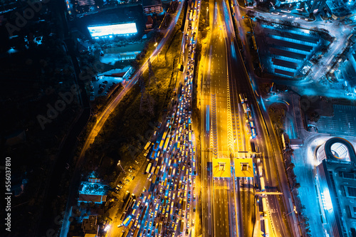 Aerial top view of Cars Passing Through The Automatic Point Of Payment On motorway Toll Road at night. Point Of Toll Highway  Toll Station. Highway Toll Plaza. night scene.