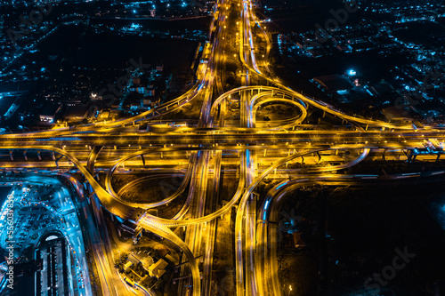 Aerial top view of Modern Multilevel Motorway Junction with Toll Highway, Road traffic an important infrastructure, Expressway Road and Roundabout, Night scene, Transportation and travel concept. photo