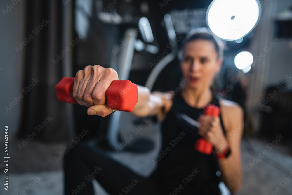 mature caucasian woman slim female use dumbbell weights for training mature caucasian woman slim female use dumbbell weights for training