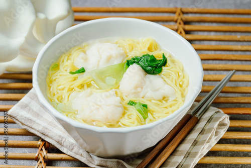 Chinese cuisine shrimp wonton dumpling noodle soup food in white bowl on white table background