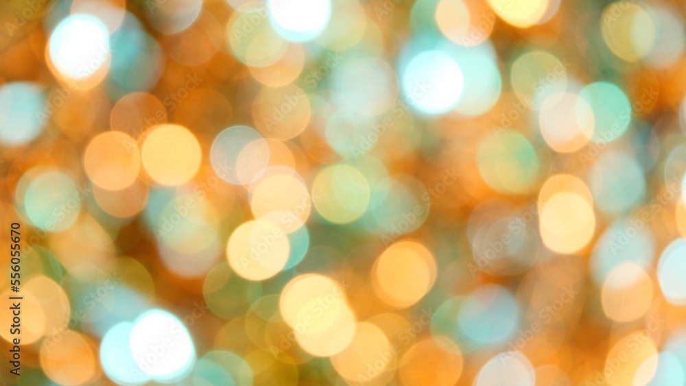 Fototapeta premium Green and yellow Christmas Festive blurred bokeh background. Glitter Soft-Focus Lights Flashing