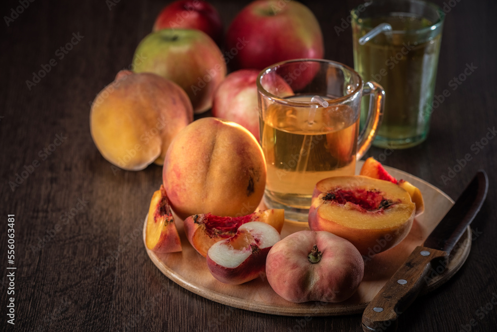 Still life of fresh peaches and apples on a dark background. Still life of fresh peaches and apples on a dark background.