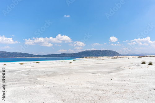 The turquoise waters of Salda Lake, the white mineral-rich beach and the blue sky. Salda Lake is a turquoise crater lake. Salda Lake, Burdur, Turkey