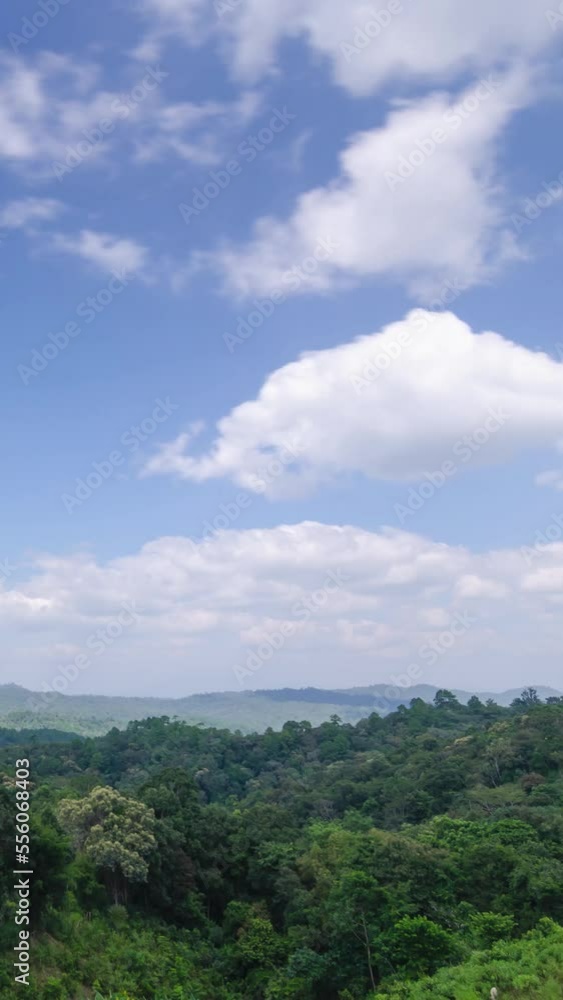 vertical timelapse view of natural winter mountain range with some cloud fog.Flores tropical paradise. Mountain Range under clear blue sky, Aerial View. vertical timelapse view of natural winter mountain range with some cloud fog.Flores tropical paradise. Mountain Range under clear blue sky, Aerial View.