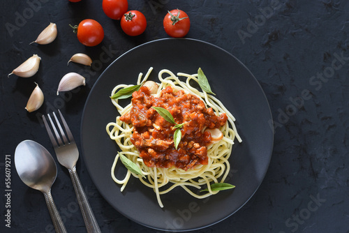 Spaghetti plate on black stone background and space for text.