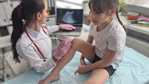 Patient is child with orthopedic doctor ultrasound of knee