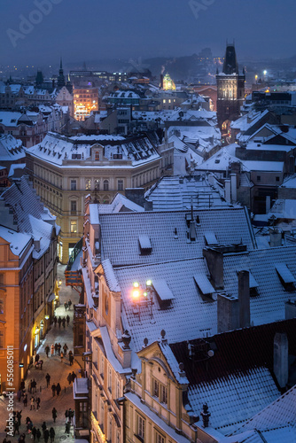 Canvas Print View of Prague roofs from the astronomical clock tower on the Old town Square with Powder tower in the background at night in winter