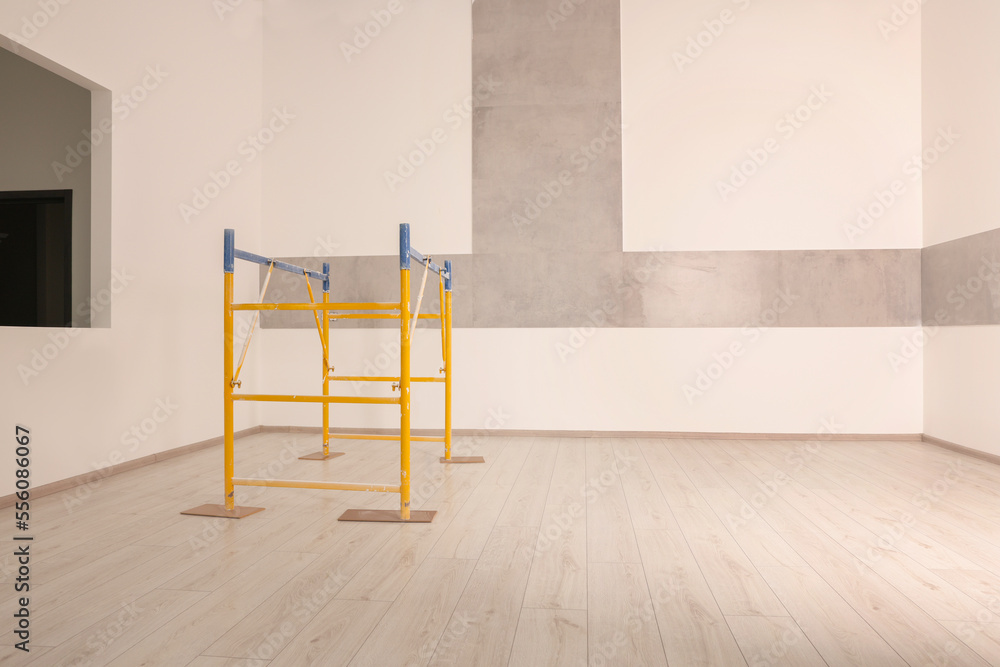 Professional construction scaffold in empty renovated room Professional construction scaffold in empty renovated room