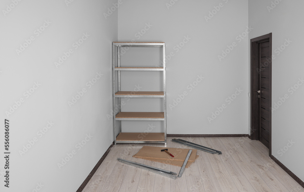 Office room with white walls and metal storage shelf