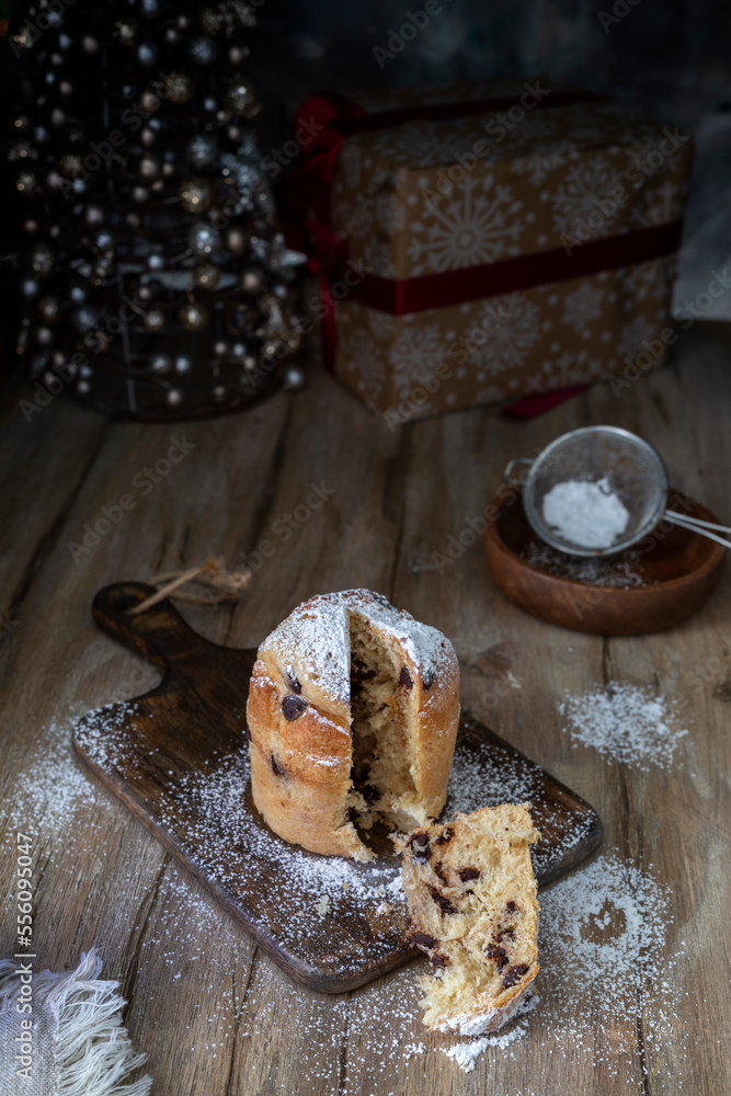 Sliced cupcake sprinkled with powdered sugar on a wooden rustic table