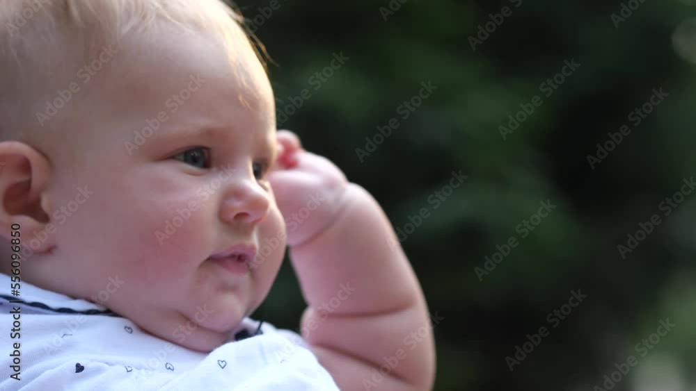 Close-up baby girl portrait. Female hands stroking kid's nose, pinching the cheeks. 4K Slow Mo Close-up baby girl portrait. Female hands stroking kid's nose, pinching the cheeks. 4K Slow Mo